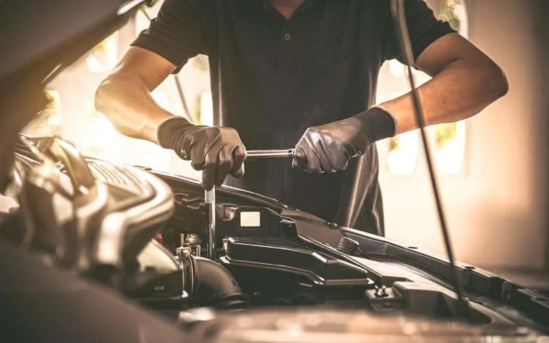Technician performing a brake repair at Albany Motorcars