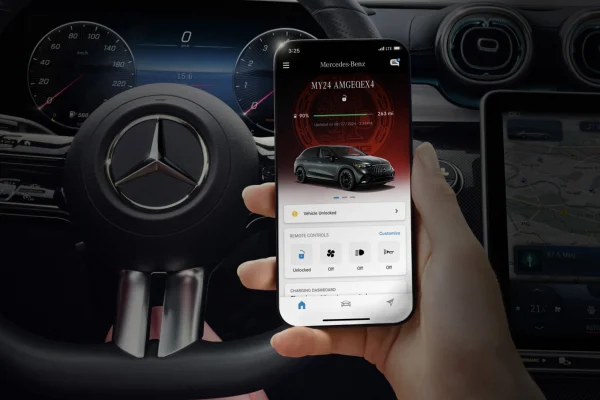 Hand holding smartphone showing the Mercedes-Benz app
