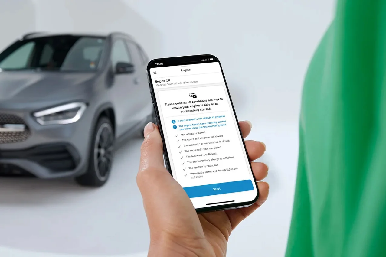 Hand holding a smartphone using Remote Engine Start in the Mercedes-Benz app