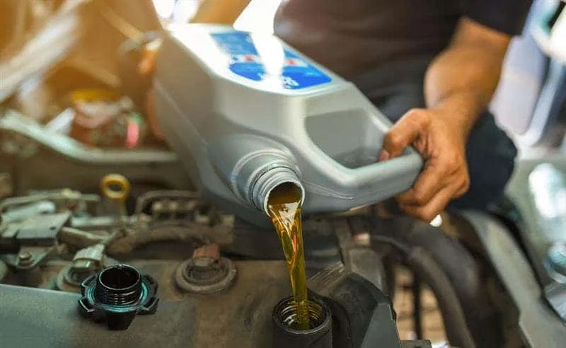 Fresh motor oil being poured during an oil change near Tifton GA