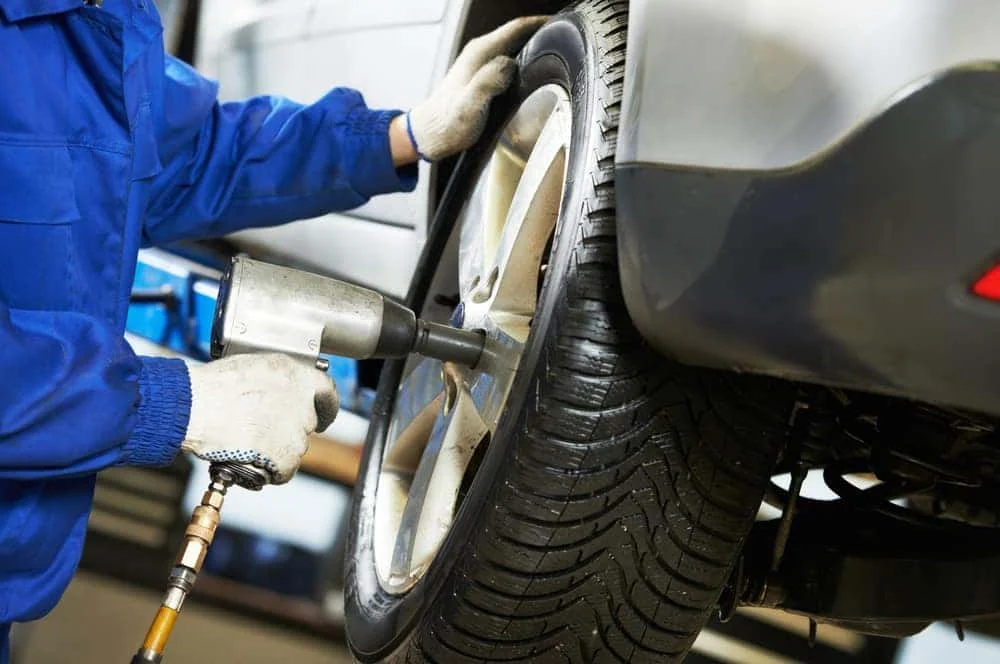Tire rotation being performed at the Albany Motorcars service center