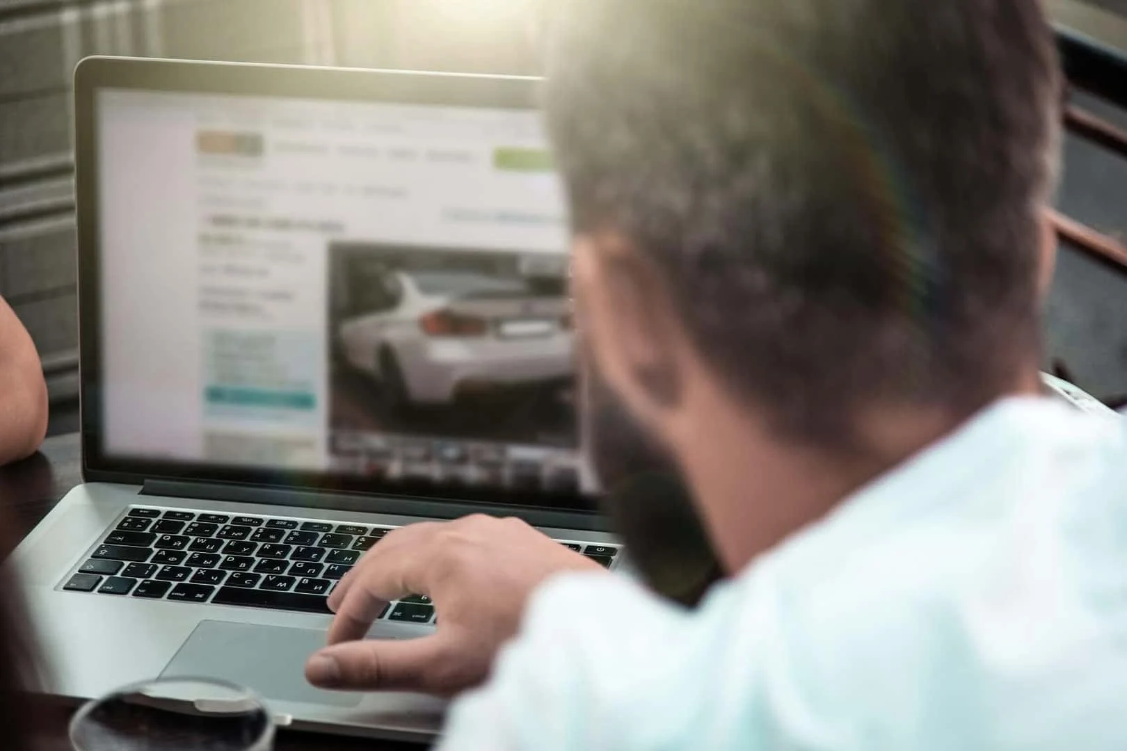 Couple shopping luxury pre-owned cars at a dealership