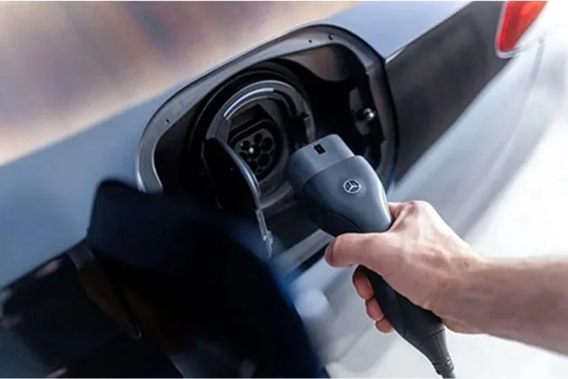 Owner plugging a charger into a Mercedes-Benz at home